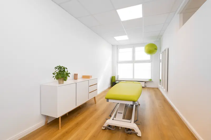 Treatment room with panoramic window and green treatment table