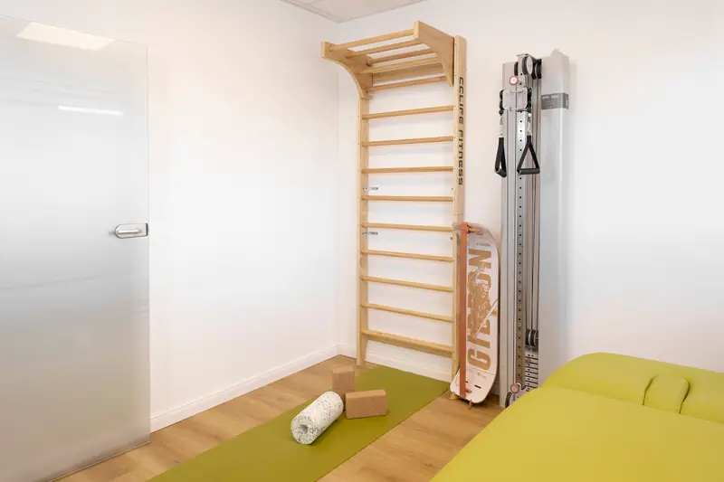 Treatment room with wall bars, cable pulley and exercise mat