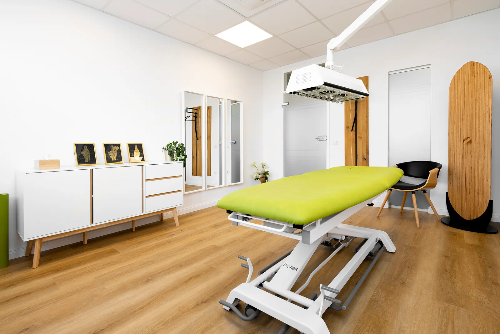 Treatment room with red light lamp and green treatment table